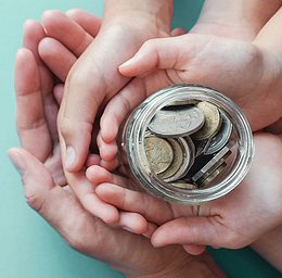 people-hands-bringing-money-together-to-donate-to-charity